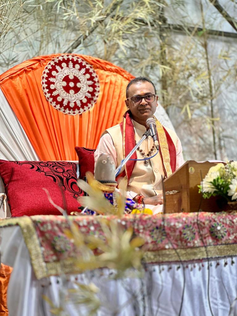 Dr Prakash Luchun conducting spiritual discourse at decorated altar